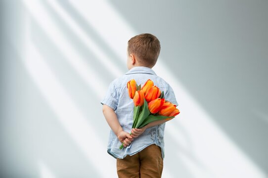 Child with beautiful bouquet of tulips. Women's Day.