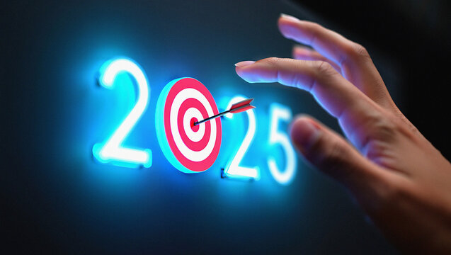 Hand aiming arrow at target in the number 2025 signifying future goals and success in the new year