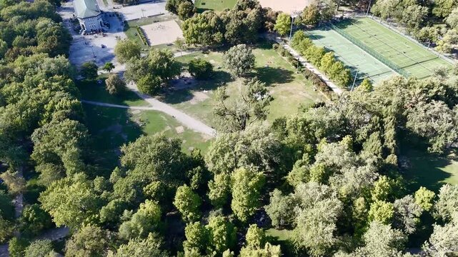 Aerial view of Montreal Parc La Fontaine with greenery and urban grid in the background. g.
