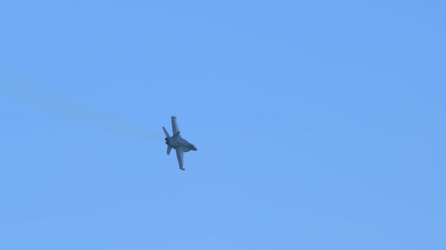 Slow motion view of F-18 fighter jets flying in the sky, showcasing military strength, speed, and precision.