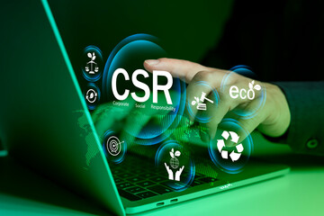CSR corporate social responsibility concept with eco icons on digital screen laptop for green...