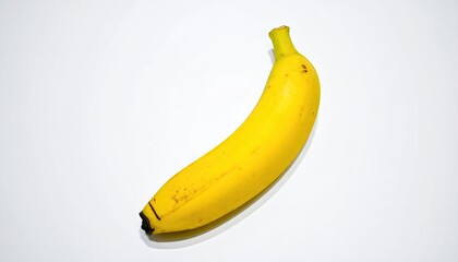 Bright yellow banana on a white background, with curved shape and small spots