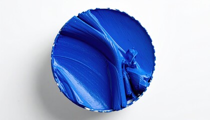 Close-up of a circular swatch of vibrant blue paint, textures visible