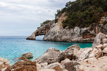 Fototapeta premium Awesome crystal clear Mediterranean sea at the eastern coast of Sardinia, Italy. Turquoise emerald water and gorgeous cliffs. Cala Goloritze, Baunei area, Sardinia.