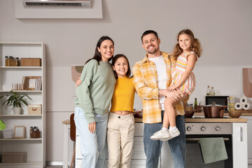 Portrait of parents with their daughters in kitchen