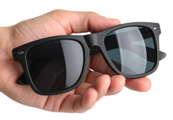 hand holding black sunglasses isolated on white background