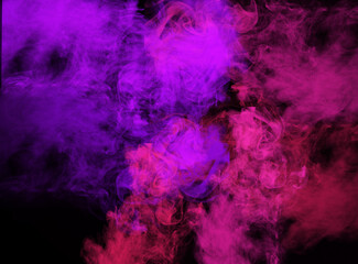 Swirling Pink and Purple Smoke Against Black Background