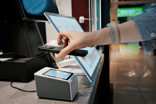 Hand Using Card Reader for Payment at Counter