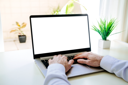 Laptop transparent screen for mockup. Over shoulder view of a young business man using a computer with empty display. Ready for use in a mock up to place your design.