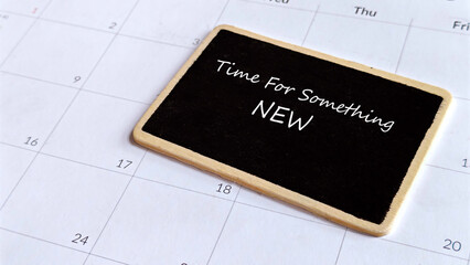 Time For Something New: Chalkboard Sign on a Calendar Emphasizing Change, Start, or Opportunity.