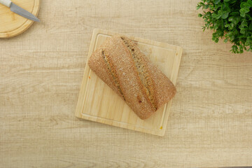 Freshly baked whole grain bread on a wooden cutting board