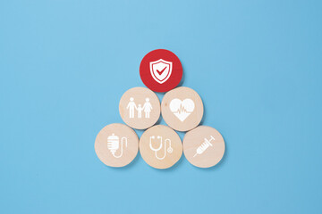 nsurance concept. Wooden blocks with insurance icons.blue background with copy space