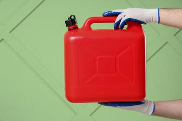 Male hands holding canister on green background