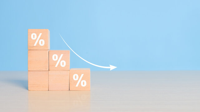 Cost reduction business finance concept, Wooden cube block with down arrows, Depreciation of national currency, inflation, investment attractiveness. Economic decline fall difficulties