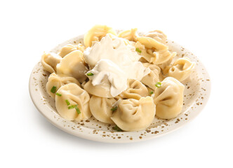 Plate of delicious boiled dumplings with sour cream and green onion on white background