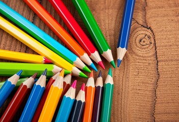 Vibrant colored pencils arranged artfully on a wooden surface,  desk,  illustration