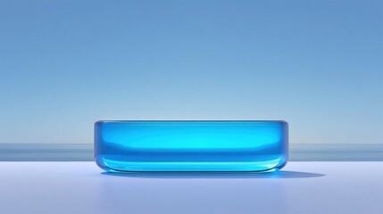 A translucent blue rectangular object with rounded edges rests on a flat surface against a calm sea and clear sky,