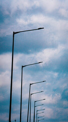 Street Light Poles Against Cloudy Sky &ndash; Urban Minimalist Architecture