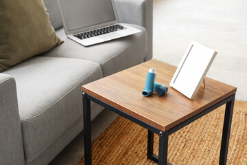 Modern inhalers and frame on coffee table in living room