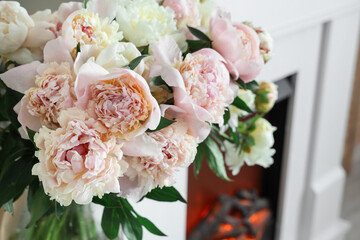 Bouquet of beautiful peonies in living room, closeup
