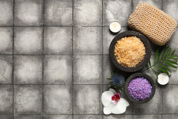 Beautiful spa composition with bowls of sea salt and candles on grey grunge background