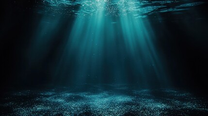 Underwater scene with sunlight beams piercing deep blue water,
