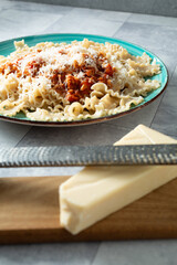 A view of a microplane grater on a block of dairy-free parmesan cheese.