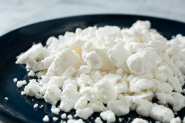 A closeup view of a pile of dairy-free feta cheese crumbles.