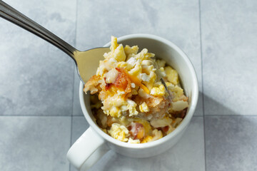 A top down view of an instant breakfast bowl, in a ceramic mug.