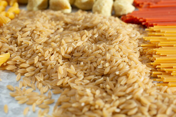 A closeup view of a pile of gluten-free orzo style pasta.