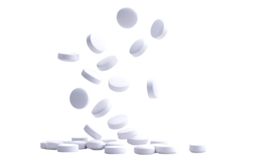 White pills scattered in mid-air, falling