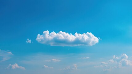 Bright blue skies with scattered clouds featuring a large cumulus cloud attached to the base,