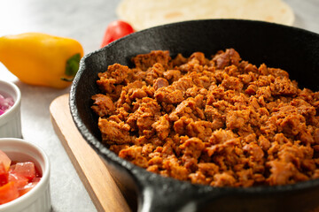 A view of chicken chorizo meat in a cast iron skillet.