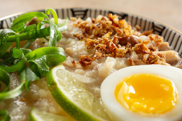 A closeup view of a bowl of arroz caldo.