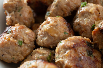A closeup view of a pile of meatballs.
