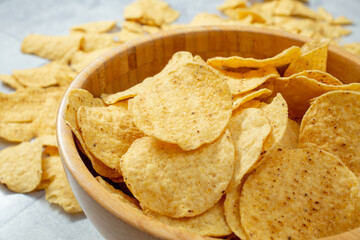 A view of a bowl of round tortilla chips.