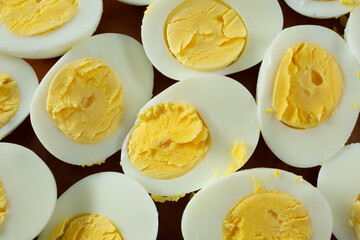 A top down view of a plate of halved 12 minute hard boiled eggs, as a background.