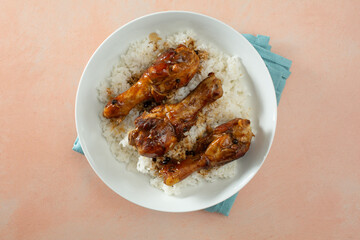 A top down view of a plate of chicken adobo.