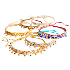 Stack of colorful bangles, adorned with gold and gems