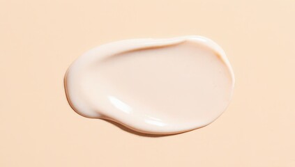 A smooth, creamy swipe of beige-toned cosmetic product on a matching soft background &mdash; minimalist, clean aesthetic perfect for skincare, makeup, or beauty product visuals.