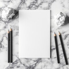 White paper, pencils, crumpled paper on marble background