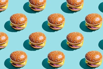 A flat lay of hamburger on a pastel blue background, the pattern is symmetrical and colorful