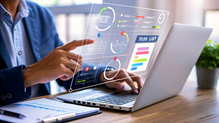 Businessman analyzing project data on transparent screen interface with laptop