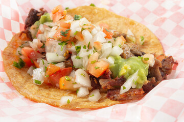 A closeup view of a carnitas taco.