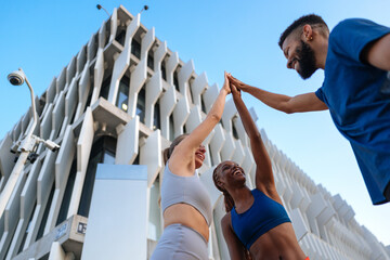 Fitness friends giving high five after training session