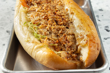 A closeup view of a loaded chicken philly sandwich.