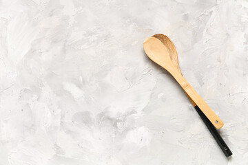 Wooden spoons on white grunge background