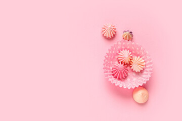 Form for baking cupcakes with sweet meringue on pink background