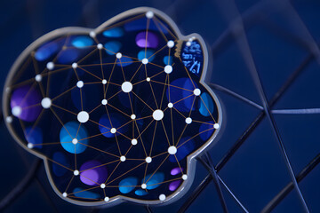 A cloud shape with network connections and blue and purple spheres on a dark blue background