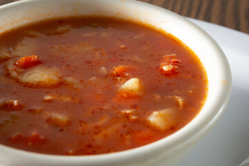 A closeup view of a bowl of manhattan clam chowder.
